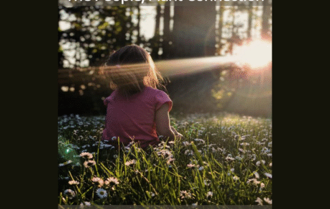 young girl looking at sunset through a forest